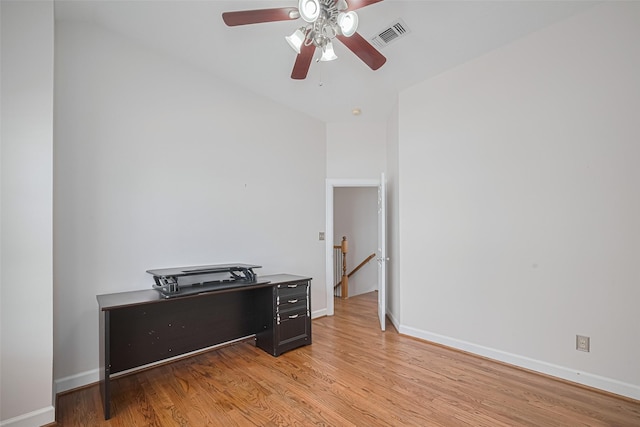 interior space featuring baseboards, visible vents, ceiling fan, and light wood-style flooring