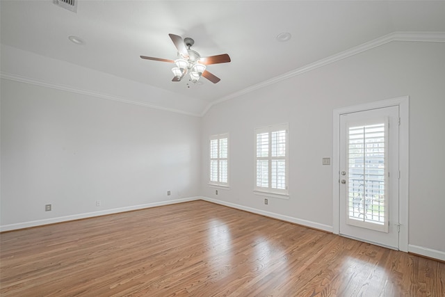 unfurnished room with ceiling fan, crown molding, light wood-style flooring, vaulted ceiling, and baseboards