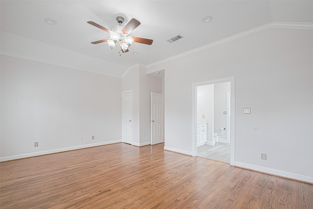 spare room featuring lofted ceiling, light wood-style flooring, ceiling fan, visible vents, and ornamental molding