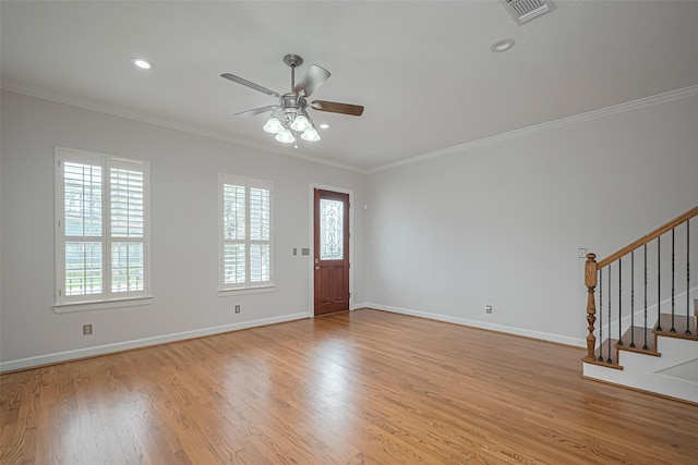 foyer featuring visible vents, a ceiling fan, stairs, and crown molding