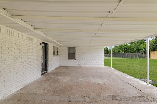 view of patio with fence and a carport