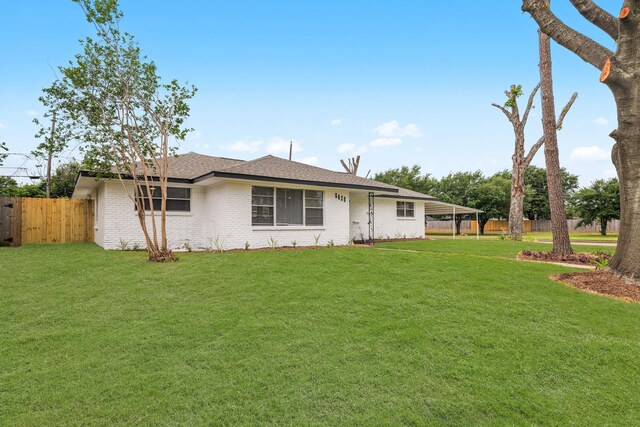 5429 De Lange Ln, Houston, TX 77092 - view of front facade with fence, a shingled roof, brick siding, and a front yard