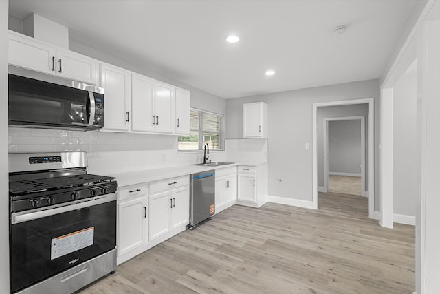 5429 De Lange Ln, Houston, TX 77092 - kitchen featuring stainless steel appliances, recessed lighting, light countertops, decorative backsplash, and light wood-style floors