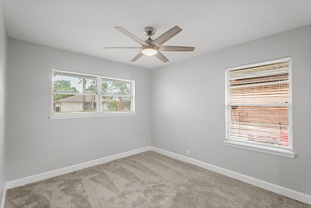 unfurnished room with carpet floors, ceiling fan, and baseboards