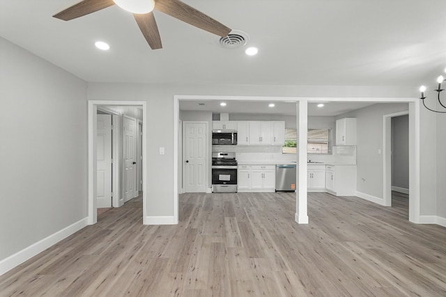 5429 De Lange Ln, Houston, TX 77092 - unfurnished living room featuring light wood finished floors, ceiling fan with notable chandelier, baseboards, and visible vents
