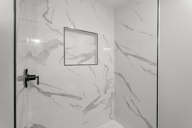 full bath featuring a marble finish shower