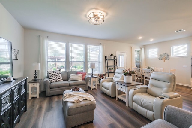 living area with visible vents, recessed lighting, and dark wood-style floors