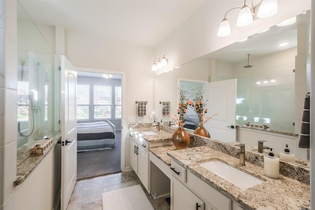 full bath featuring double vanity, a sink, tile patterned floors, and tiled shower
