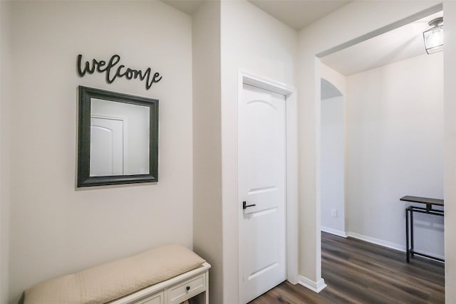 mudroom featuring dark wood-style floors and baseboards