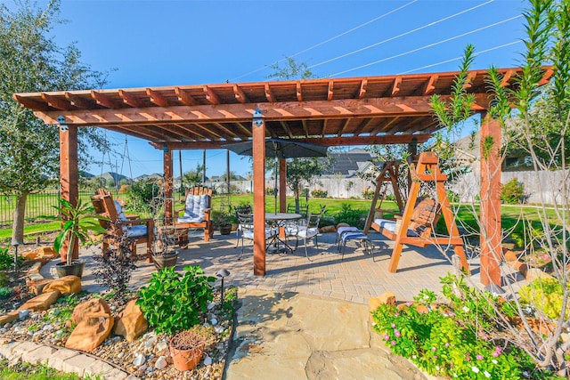 view of patio / terrace with fence, outdoor dining area, and a pergola