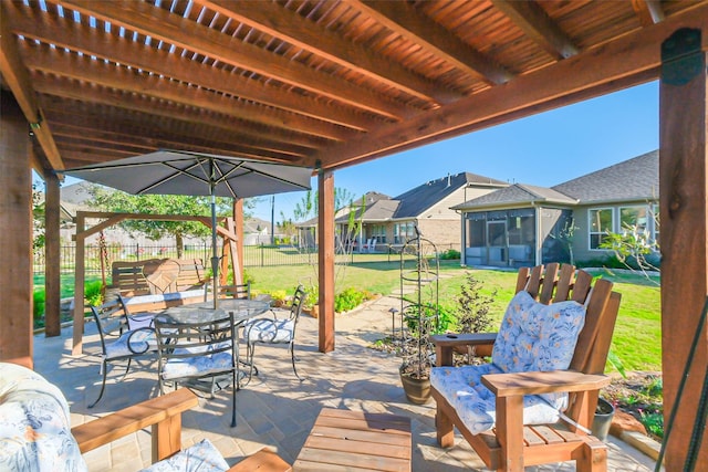 view of patio / terrace with a residential view, a sunroom, outdoor dining space, and a fenced backyard