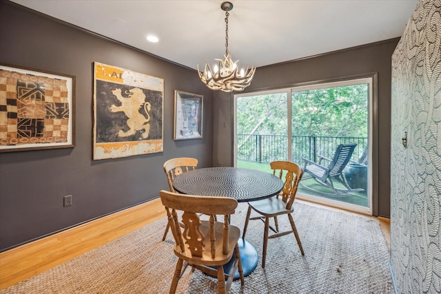 dining area featuring a chandelier, wood finished floors, and recessed lighting