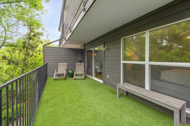 exterior space with a lawn and a balcony