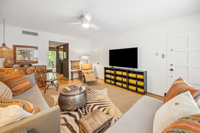 living area featuring ceiling fan, visible vents, and wood finished floors