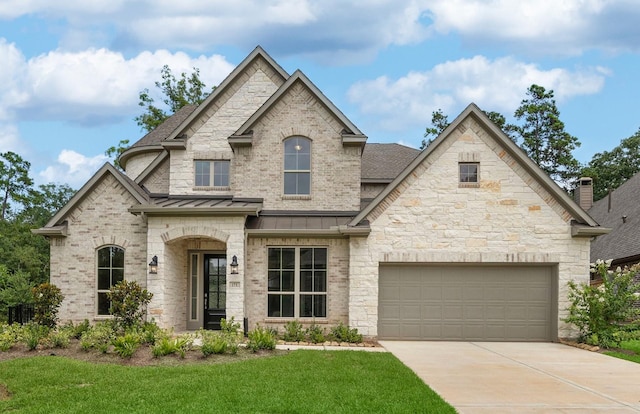 10719 Jacobina Ct, Cypress, TX 77433 - french country home featuring a standing seam roof, a garage, roof with shingles, a front lawn, and concrete driveway