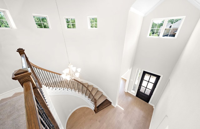10719 Jacobina Ct, Cypress, TX 77433 - stairway featuring an inviting chandelier, wood finished floors, plenty of natural light, and high vaulted ceiling