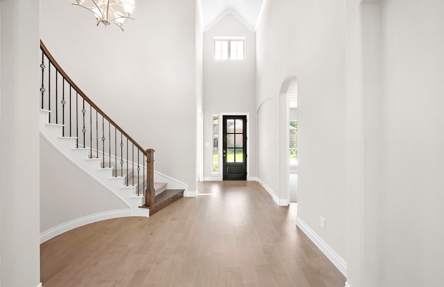 10719 Jacobina Ct, Cypress, TX 77433 - entryway with stairway, a chandelier, arched walkways, wood finished floors, and a high ceiling
