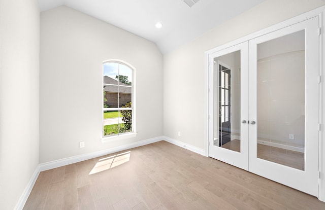 10719 Jacobina Ct, Cypress, TX 77433 - spare room featuring wood finished floors, french doors, and vaulted ceiling