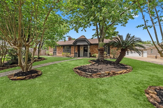 view of front of home featuring a chimney, brick siding, fence, and a front yard
