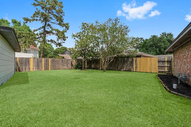 view of yard with a fenced backyard