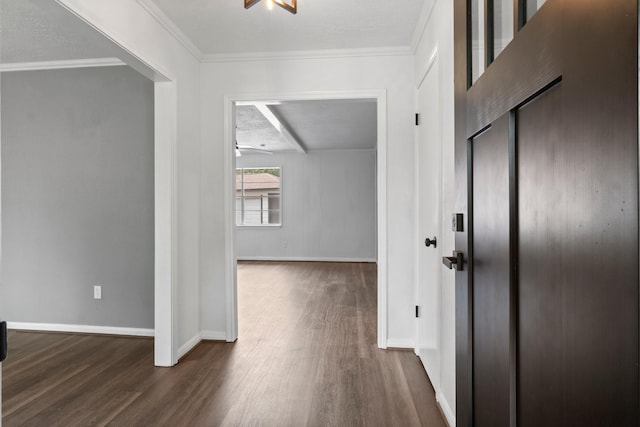 corridor featuring dark wood finished floors, baseboards, and crown molding