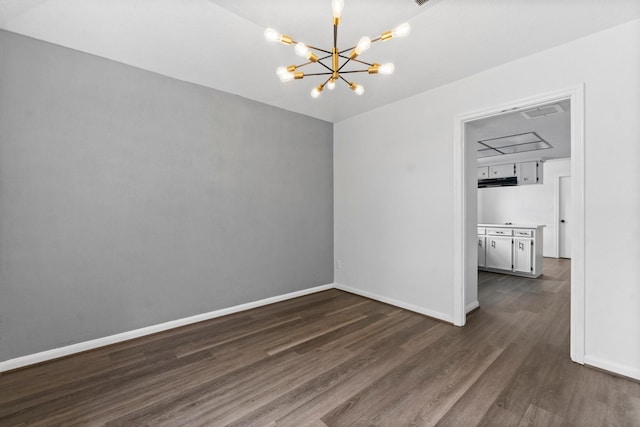 unfurnished dining area with dark wood-style floors, a notable chandelier, and baseboards