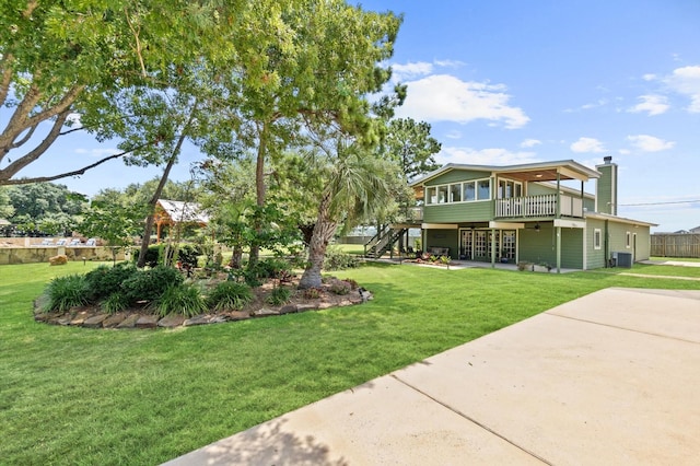 11008 Hillside Dr, Willis, TX 77318 - view of front of property featuring stairs, a wooden deck, a front yard, a chimney, and french doors