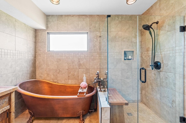 11008 Hillside Dr, Willis, TX 77318 - full bathroom featuring vanity, tile walls, a shower stall, and a freestanding bath
