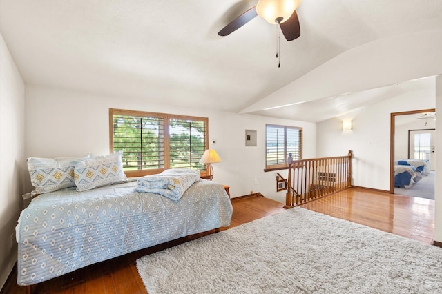 11008 Hillside Dr, Willis, TX 77318 - bedroom with multiple windows, wood finished floors, and lofted ceiling