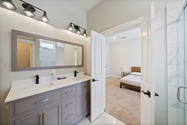 full bathroom featuring double vanity, a shower stall, ensuite bathroom, and a sink