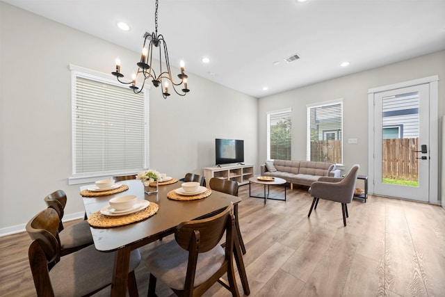 dining space with a chandelier, recessed lighting, and light wood-style floors