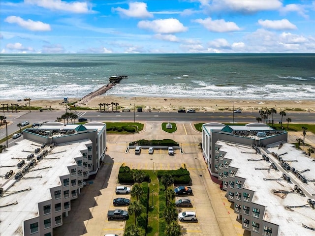 drone / aerial view with a beach view and a water view