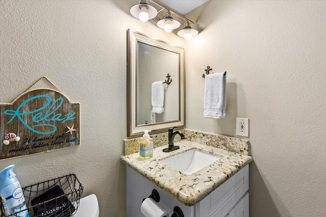 bathroom with toilet and vanity