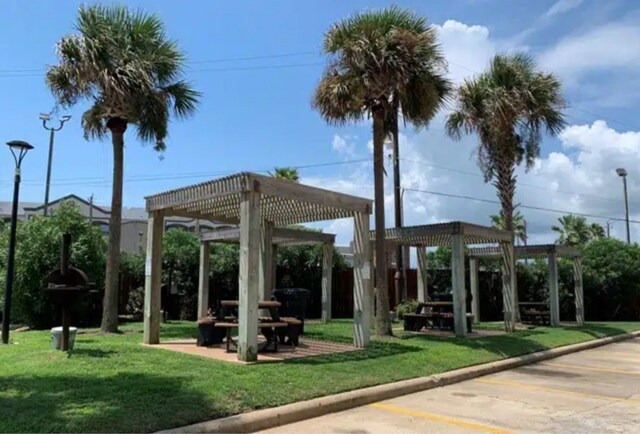 view of property's community featuring a pergola and a yard