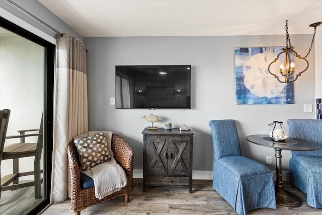 living area featuring wood finished floors and a chandelier