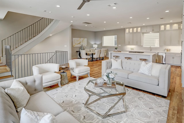 living room featuring visible vents, ceiling fan, light wood-style flooring, and recessed lighting
