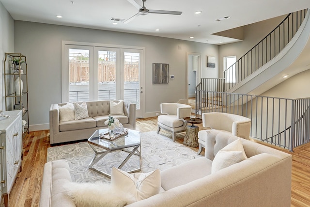 living area featuring visible vents, ceiling fan, light wood-style flooring, and baseboards