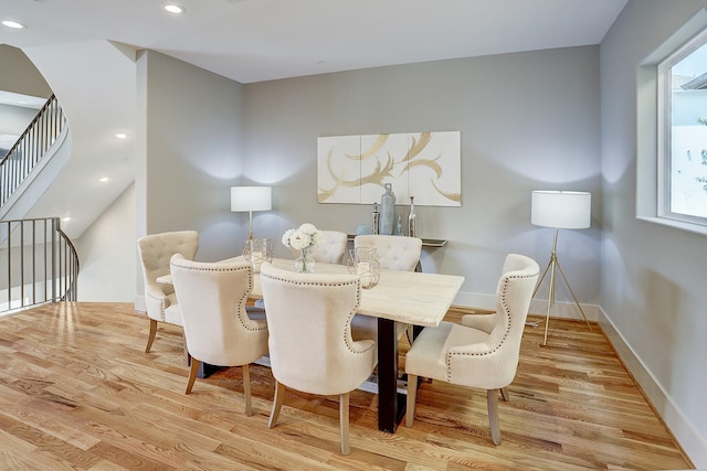 dining room featuring wood finished floors, recessed lighting, and baseboards