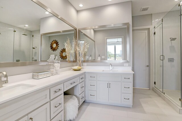 bathroom featuring visible vents, a stall shower, and a sink