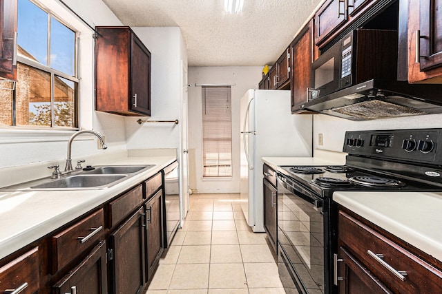 kitchen featuring light tile patterned floors, light countertops, black appliances, a sink, and a textured ceiling