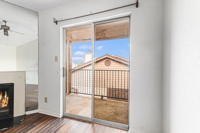 entryway with baseboards, wood finished floors, and a ceiling fan