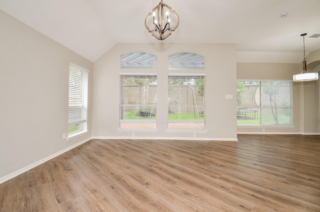 interior space featuring wood finished floors, a wealth of natural light, and a chandelier