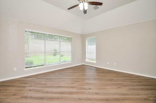 spare room featuring ceiling fan, plenty of natural light, visible vents, and baseboards