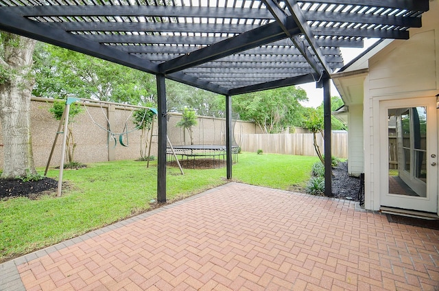 view of patio featuring a trampoline and a fenced backyard