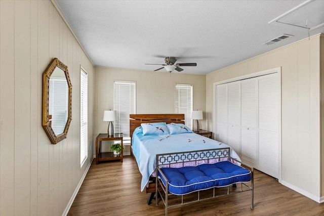 4311 Spanish Main, Jamaica Beach, TX 77554 - bedroom featuring wood finished floors, attic access, baseboards, visible vents, and a textured ceiling