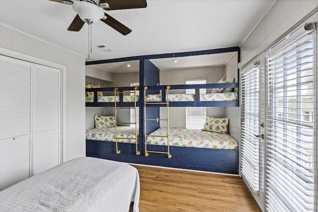 4311 Spanish Main, Jamaica Beach, TX 77554 - bedroom with visible vents, ceiling fan, a closet, ornamental molding, and wood finished floors