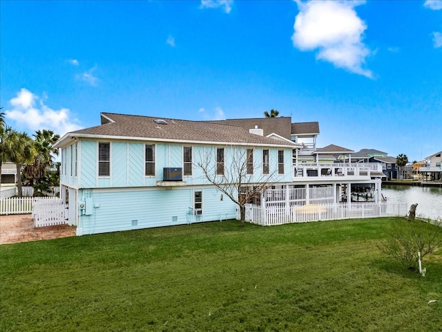 4311 Spanish Main, Jamaica Beach, TX 77554 - rear view of property featuring fence, a lawn, a water view, and a patio