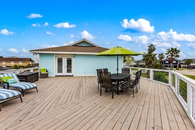 4311 Spanish Main, Jamaica Beach, TX 77554 - wooden deck featuring outdoor dining space, french doors, and a residential view