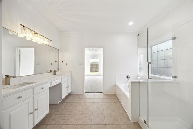 bathroom featuring crown molding, a garden tub, a sink, and double vanity