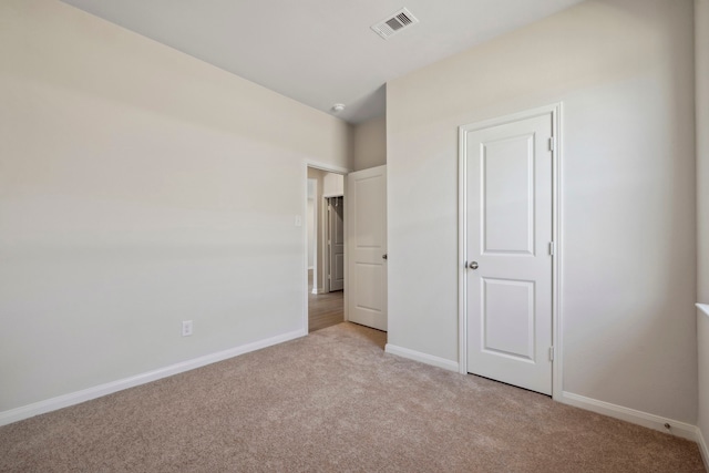 unfurnished bedroom featuring visible vents, baseboards, and light carpet